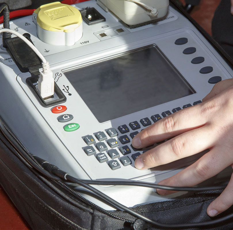 Close up of hand on a pat testing machine